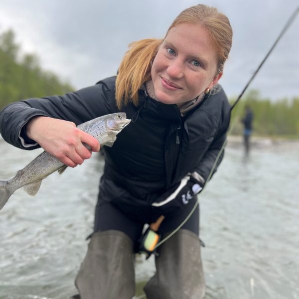 a person standing next to a body of water
