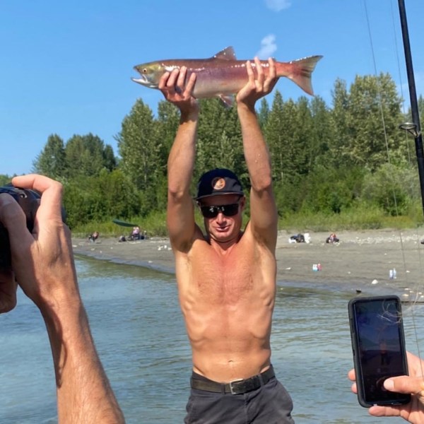 a man holding a fish in the water