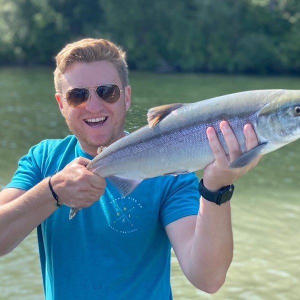 a man holding a fish in the water
