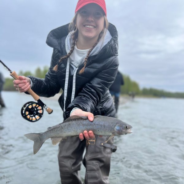 a person holding a fish in the water