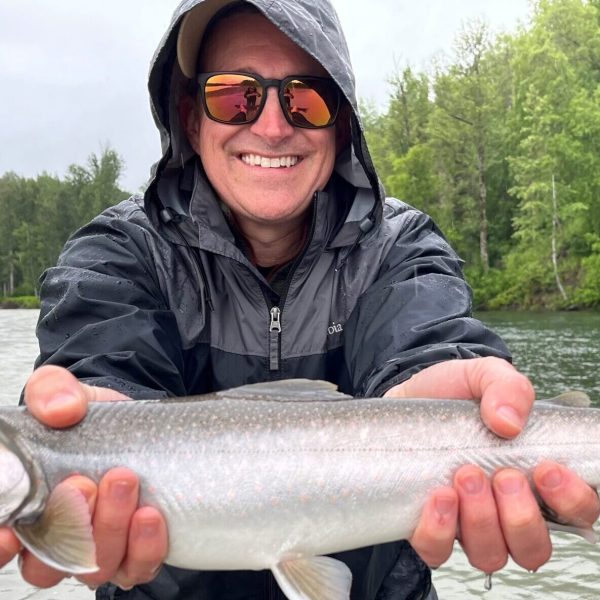 a man holding a fish in the water