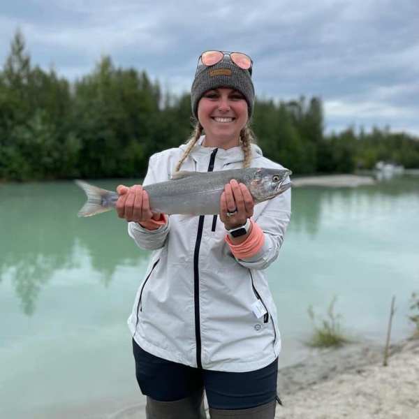 a person standing next to a body of water