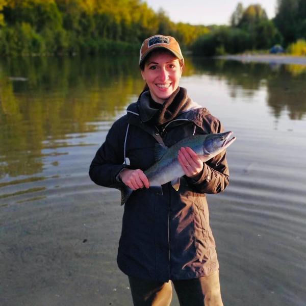 a person standing next to a body of water
