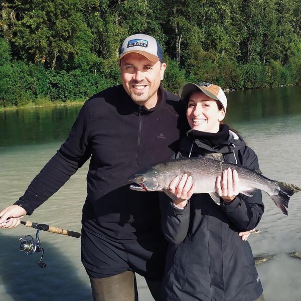 a person holding a fish in the water