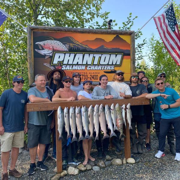 a group of people standing in front of a fence