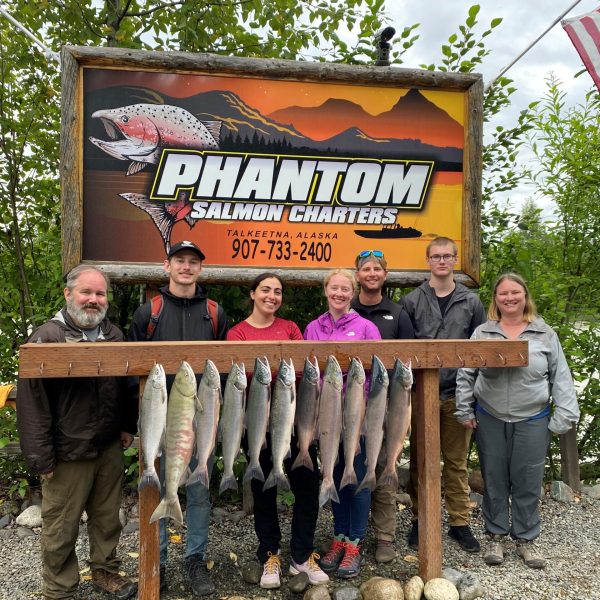 Lance Norris, Alicia Quezada sitting on a bench posing for the camera