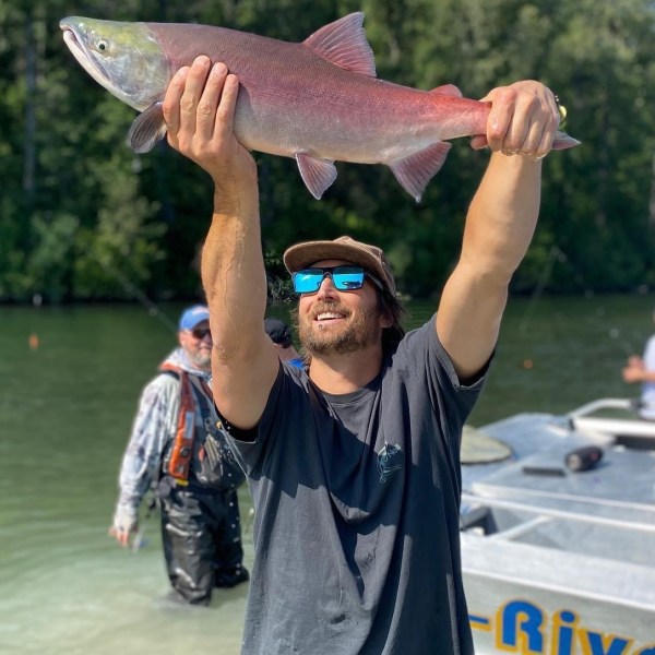 a person holding a fish