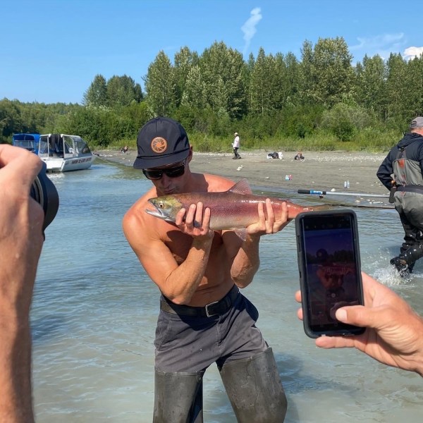 a group of people standing next to a lake