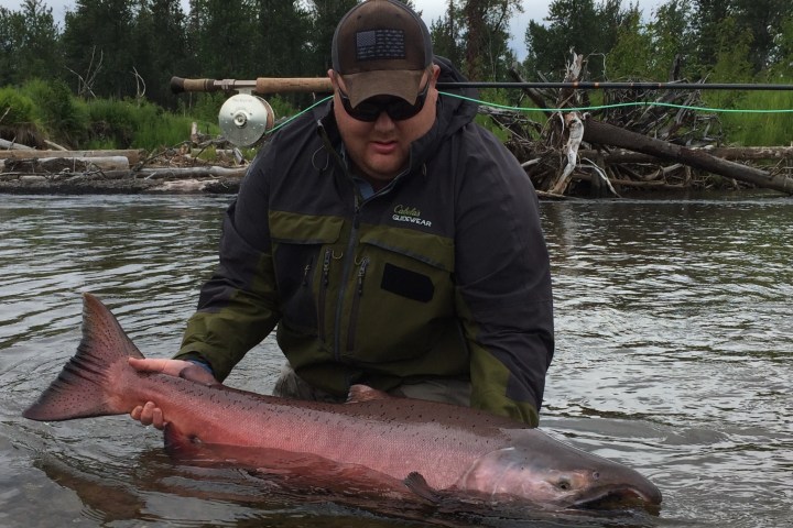 a man holding a fish in the water