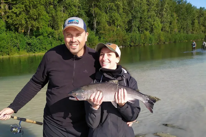 Troy Olsen holding a fish in the water