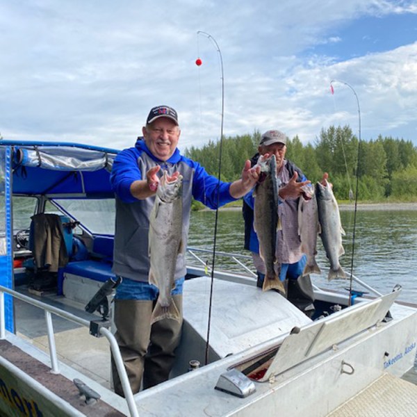a person standing in front of a boat next to a body of water