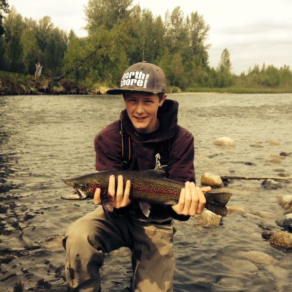 a man standing next to a body of water