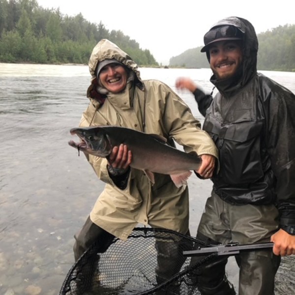 a person holding a fish in the water