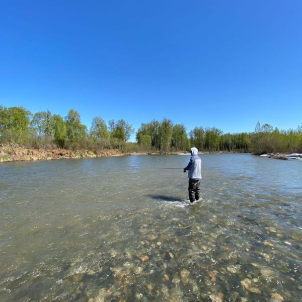 a man standing next to a body of water