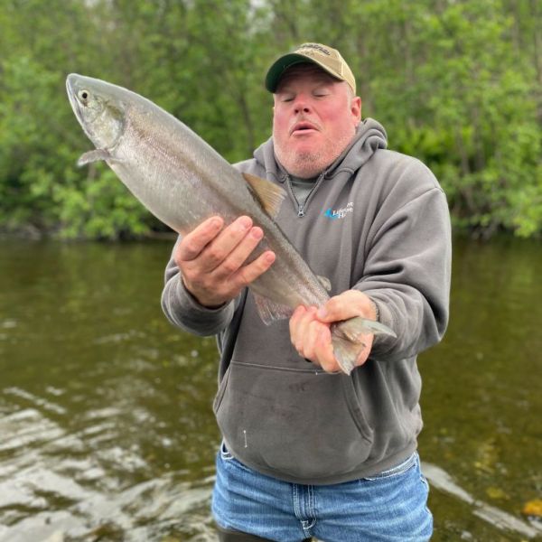 a man standing next to a body of water