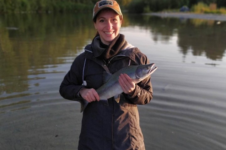 a person standing next to a body of water