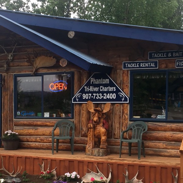 a wooden bench in front of a store