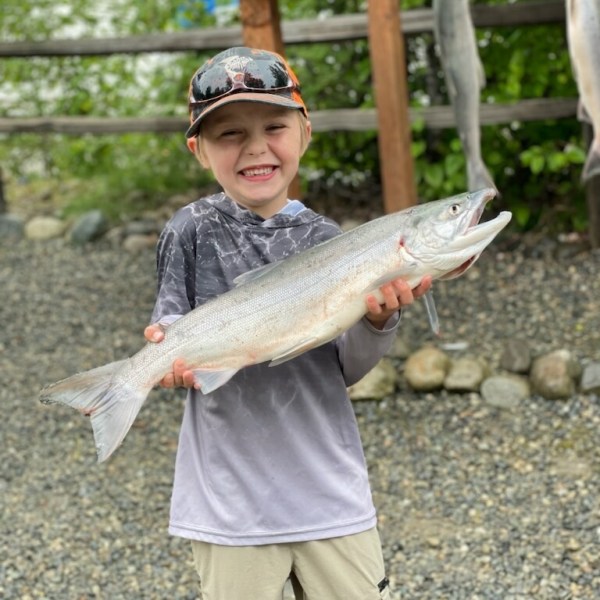 a little boy holding a fish
