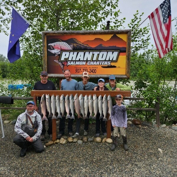 a group of people standing in front of a sign