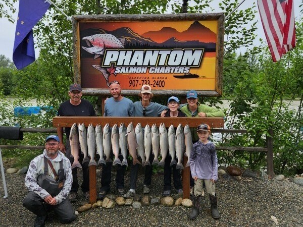 a group of people standing in front of a sign