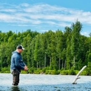 a man standing next to a body of water