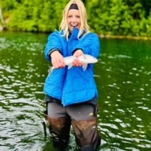 a person standing next to a body of water