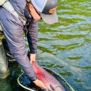 a person holding a fish in the water