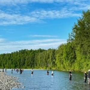 a group of people standing next to a body of water
