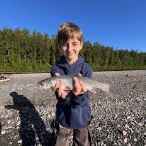 a little boy that is standing in the dirt