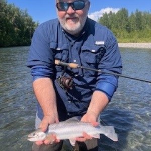 a man holding a fish in the water