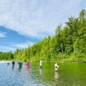 a group of people standing next to a body of water