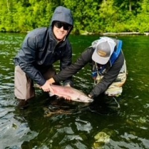 a man holding a fish in the water