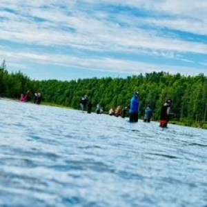 a group of people skiing on the water