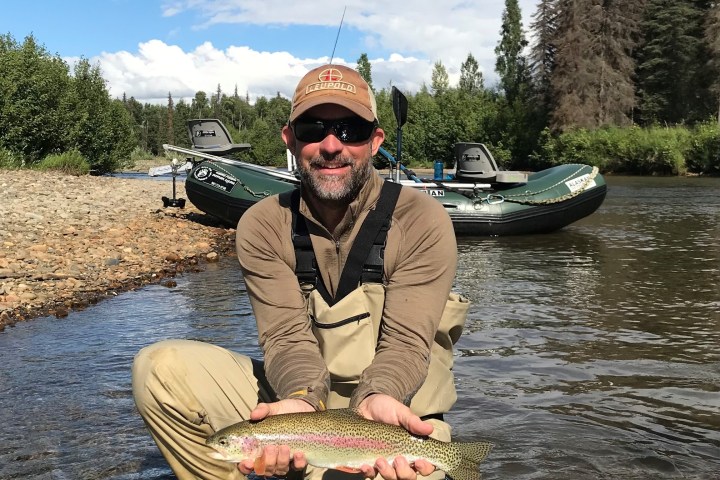 a man holding a fish in the water